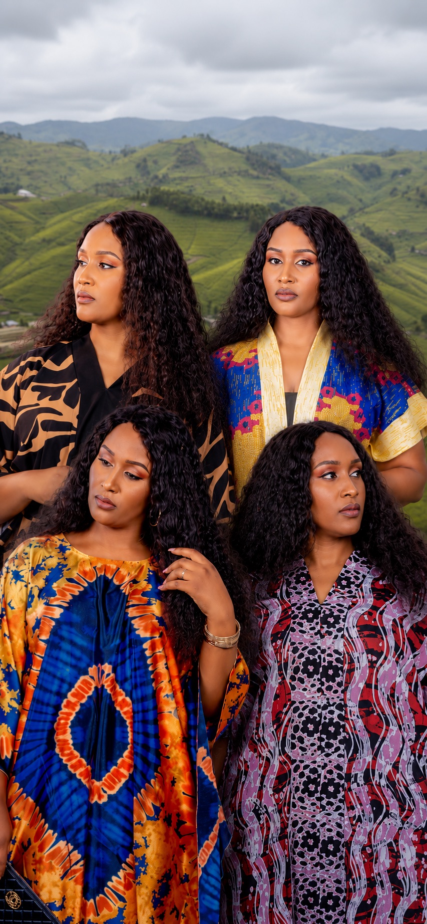 Four women in ANTOSTYLE kaftans and boubous before the hills of Rwanda